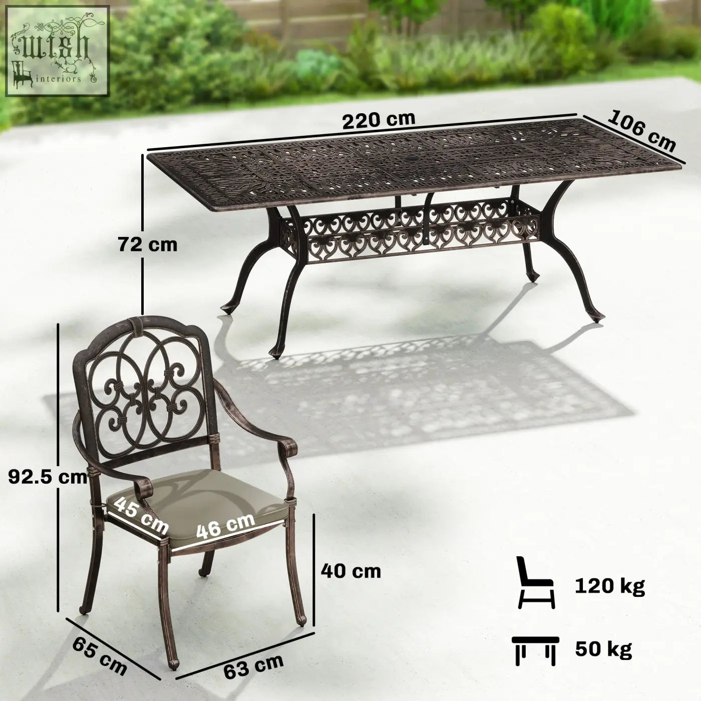 Dark bronze cast aluminium garden dining set with ornate scrollwork table and cushioned armchair for patio use