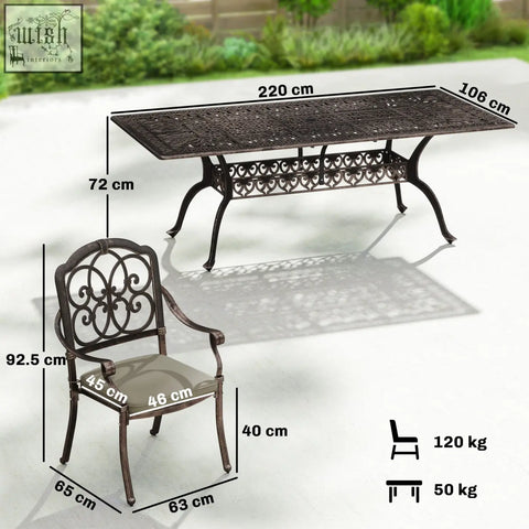 Dark bronze cast aluminium garden dining set with ornate scrollwork table and cushioned armchair for patio use