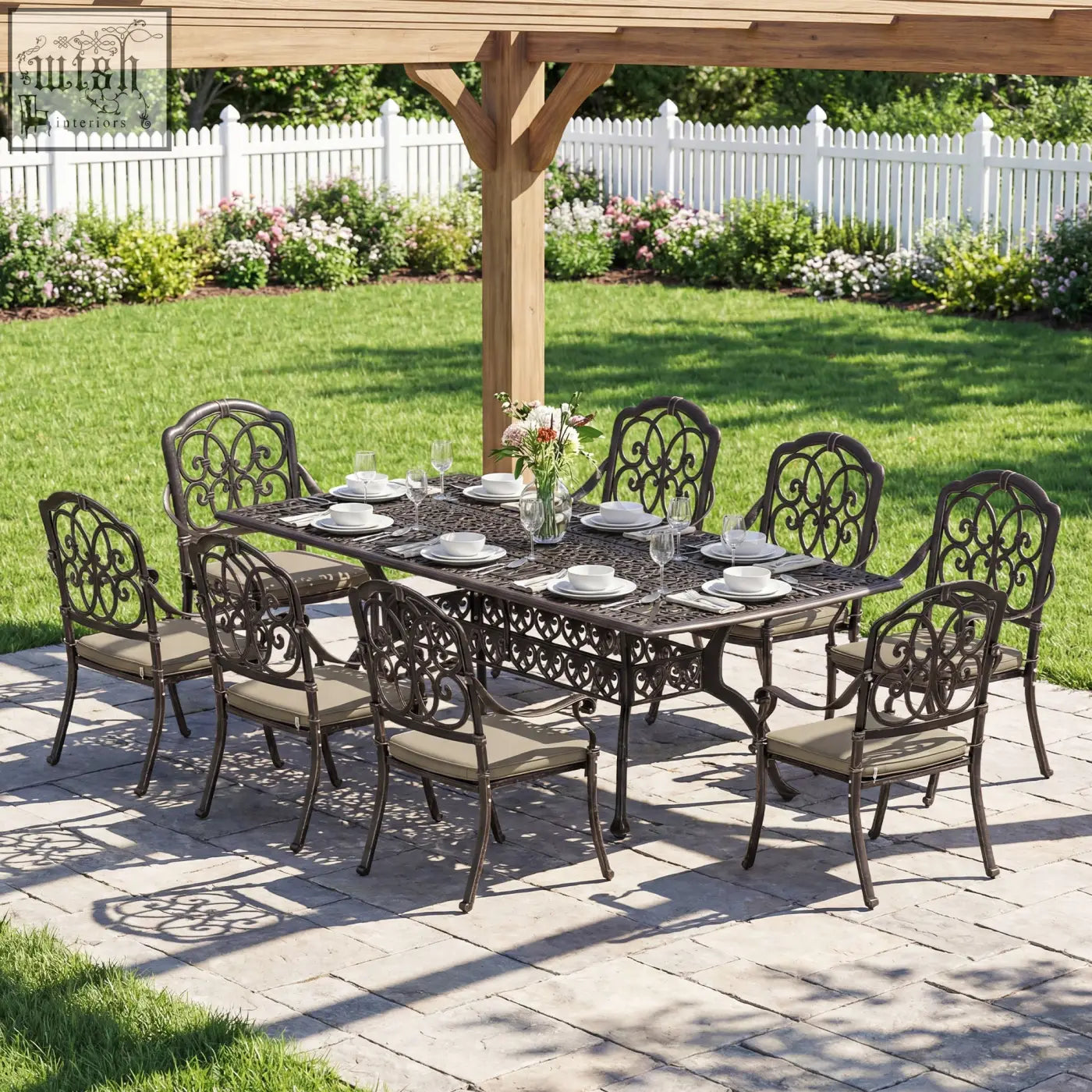 Black wrought iron garden dining set with ornate scrollwork beige cushioned seats cast aluminium bronze tone patio