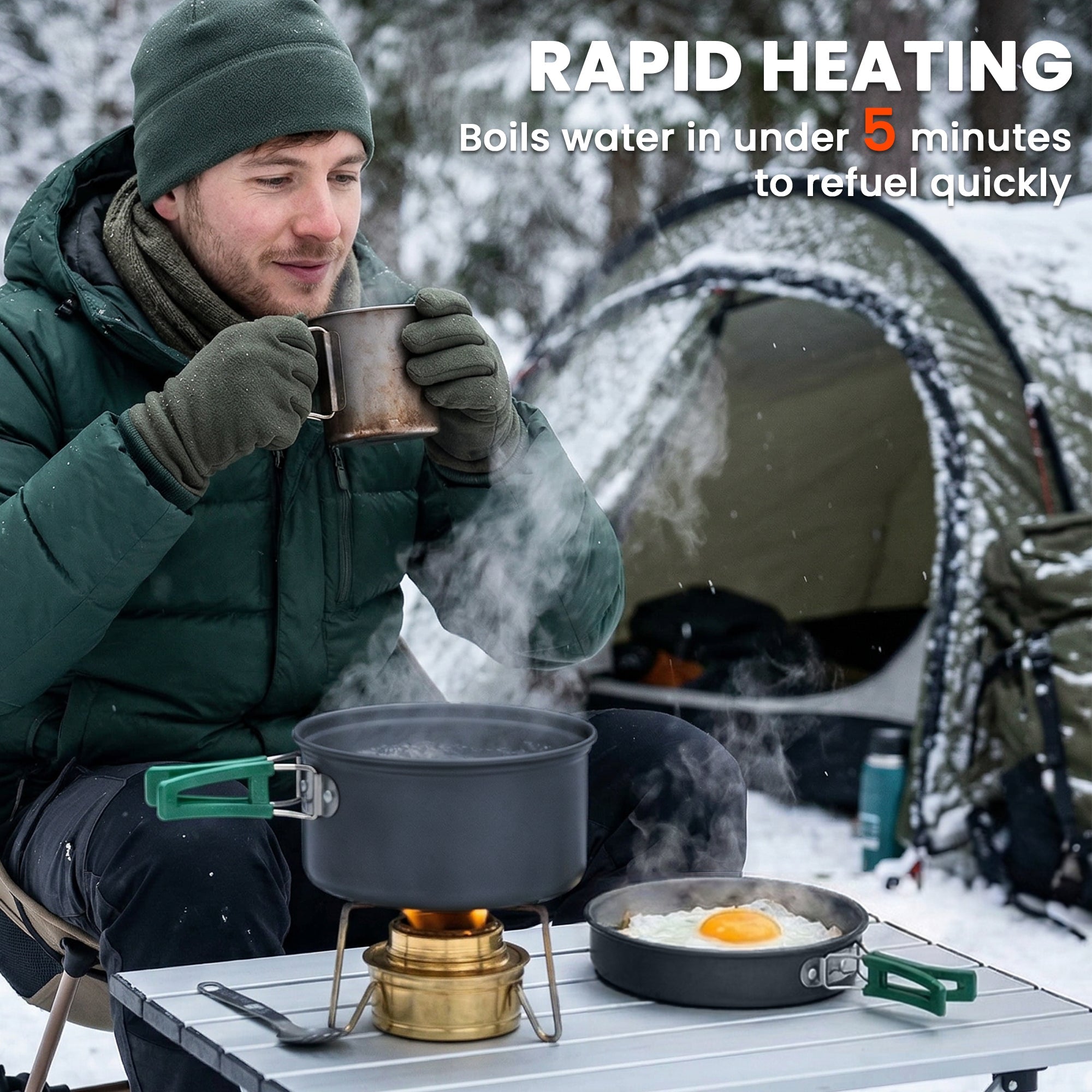 Black outsunny camping pot with green anti-scald handles on a portable stove for camping cooking in snowy outdoors