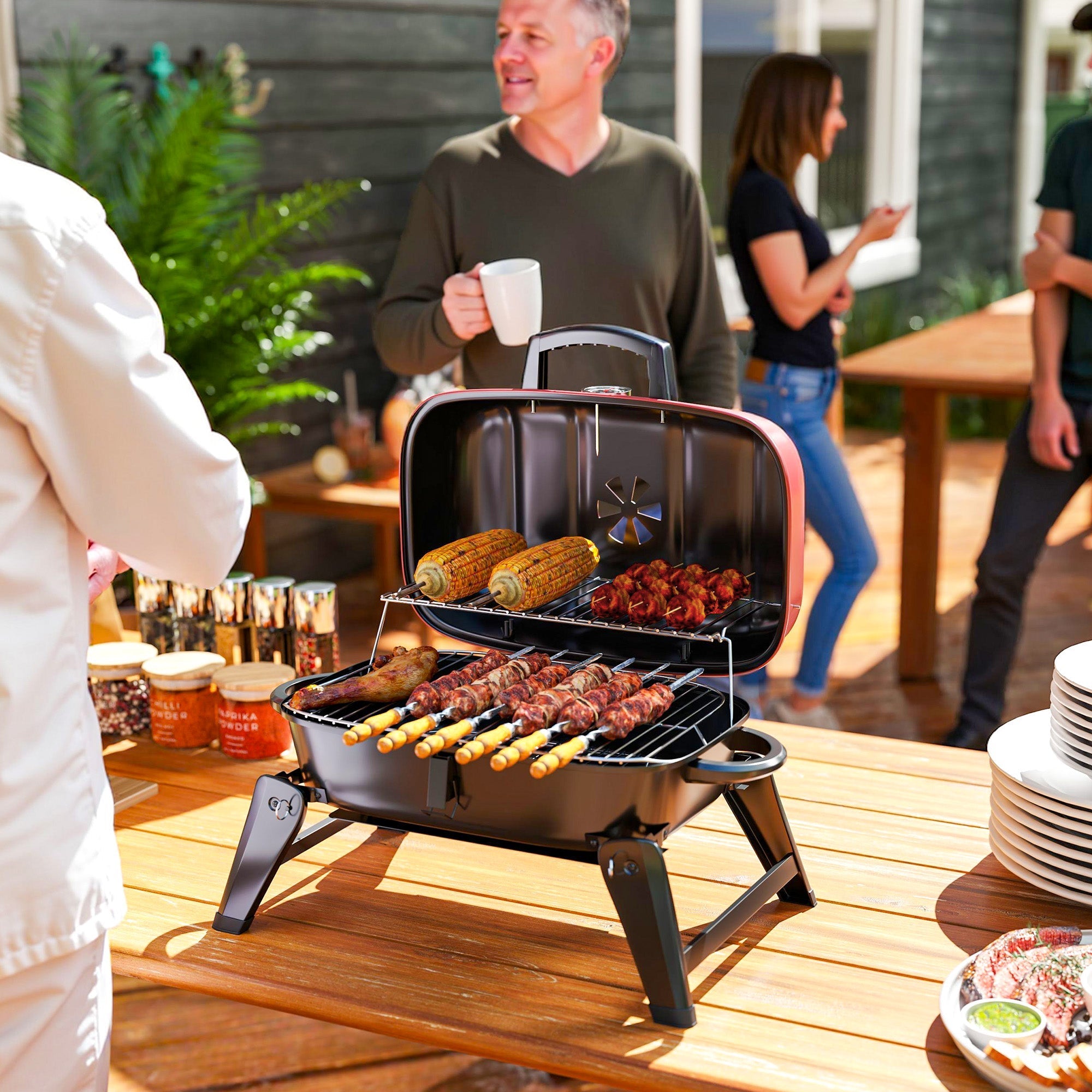 Outsunny charcoal barbecue grill in black and red with warming rack grill grate and adjustable legs for camping use