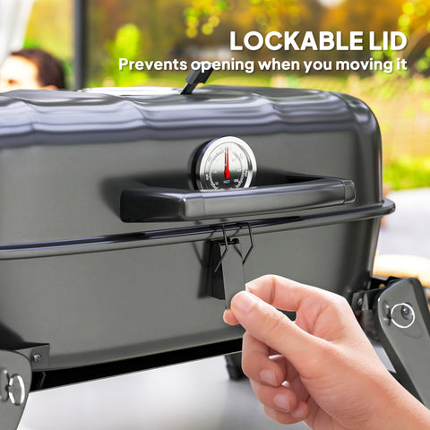 Black Outsunny charcoal barbecue grill with lockable lid, built-in thermometer, grill grate, and warming rack for camping