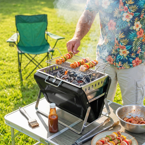 Black Outsunny portable charcoal grill with stainless steel grates and tilting grate for easy add charcoal grilling