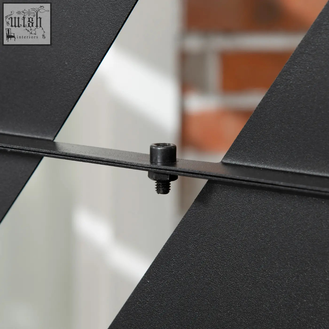 Black metal expansion screws securing two angled panels on the back of outsunny banana leaf privacy screen