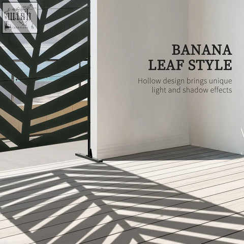 Black metal banana leaf privacy screen with hollow design casting geometric shadows and expansion screws on floor