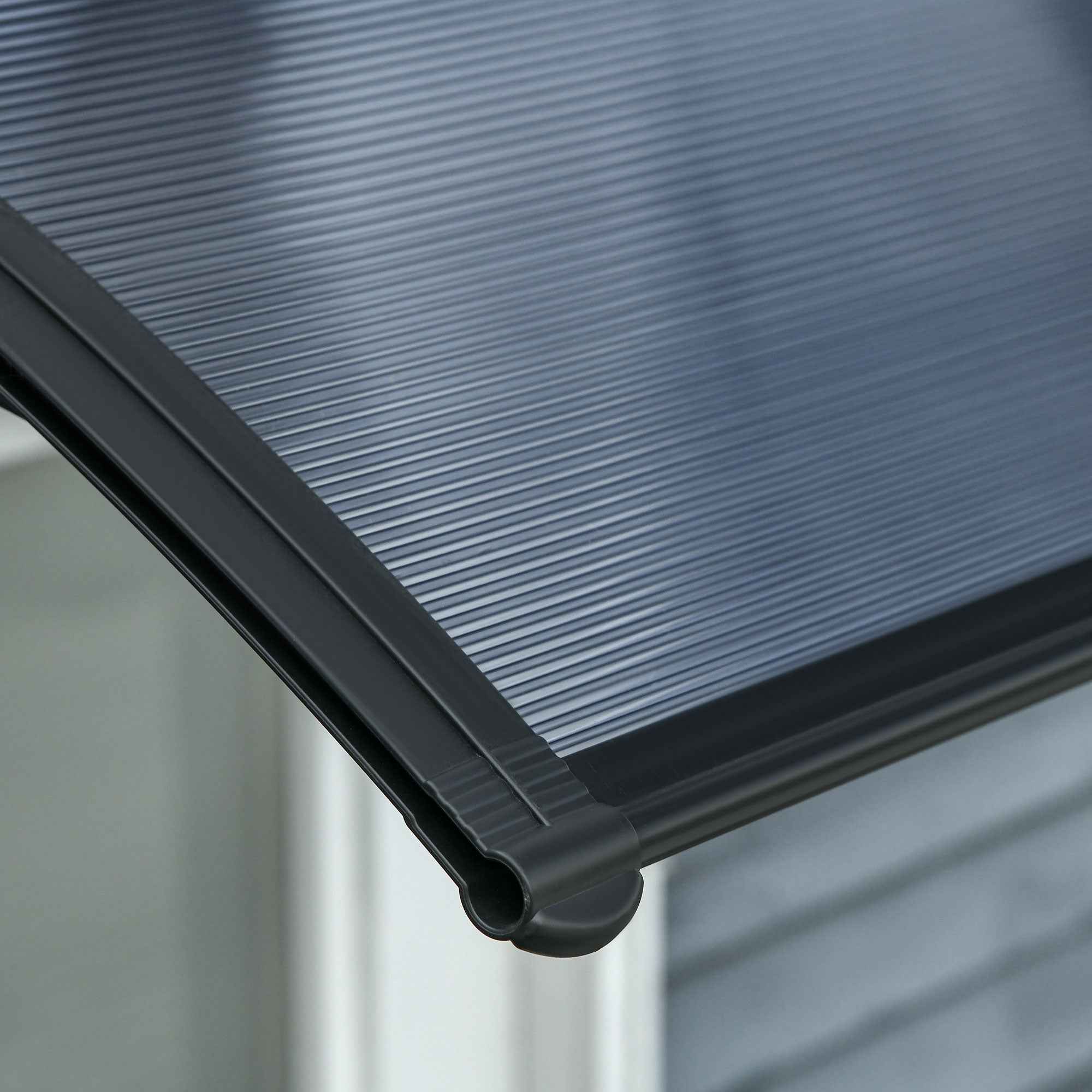 Outsunny black plastic door canopy awning with ribbed translucent surface and reinforced trim protects from light snow outdoors