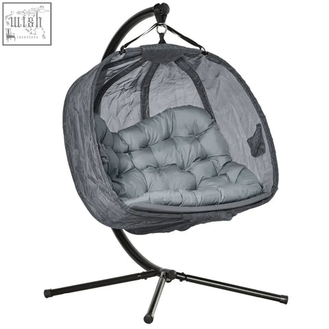Gray mesh hanging egg chair with cushioned seat and black metal stand perfect for indoor outdoor seating