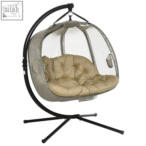Beige cushioned hanging egg chair with mesh enclosure and black metal frame seat basket for indoor and outdoor use