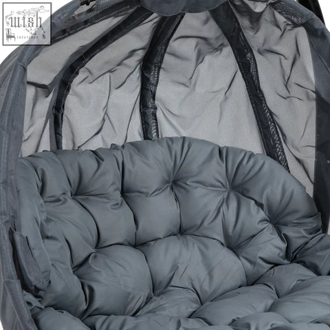 Gray quilted cushion with tufted design inside mesh canopy of outsunny hanging egg chair seat basket for indoor outdoor use