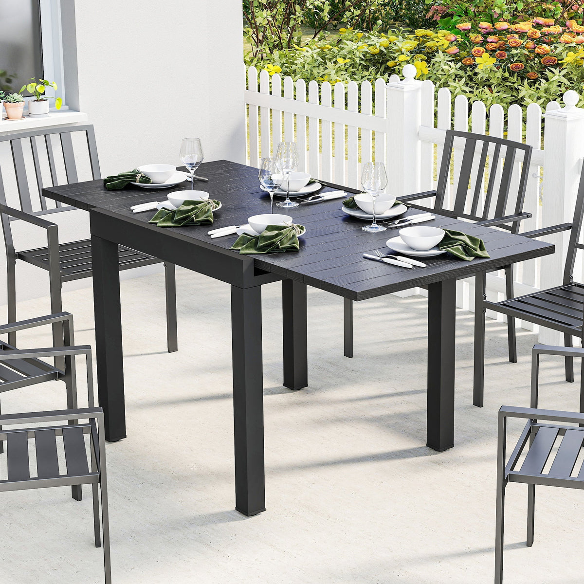 Black outsunny extendable garden table with faux wood top and sturdy metal legs for outdoor dining
