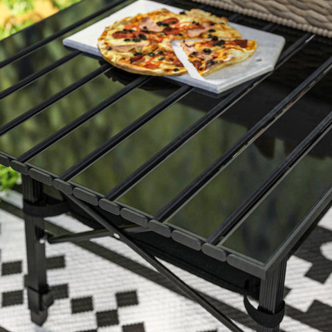 A black glass-top outsunny camping table with metal frame, oxford cloth storage basket, and height adjustable legs