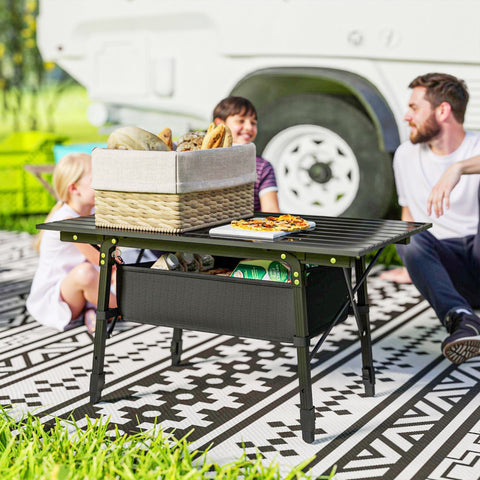 Black outsunny camping table with foldable aluminum frame green accent legs and oxford cloth storage basket