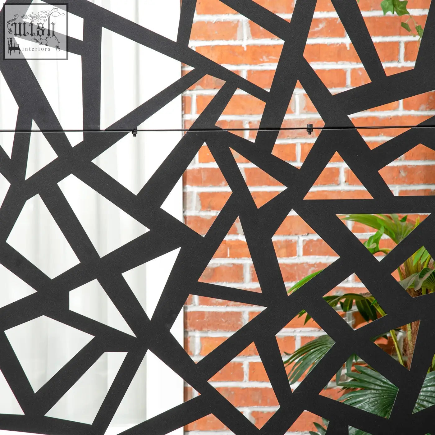 Black geometric metal privacy screen with intersecting triangles, two long legs, and expansion screws for outdoor use