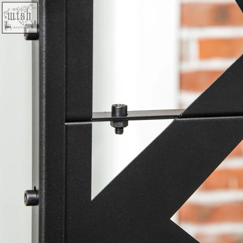 Black metal freestanding garden partition screen with matte finish, geometric design, two long legs, and expansion screws for privacy