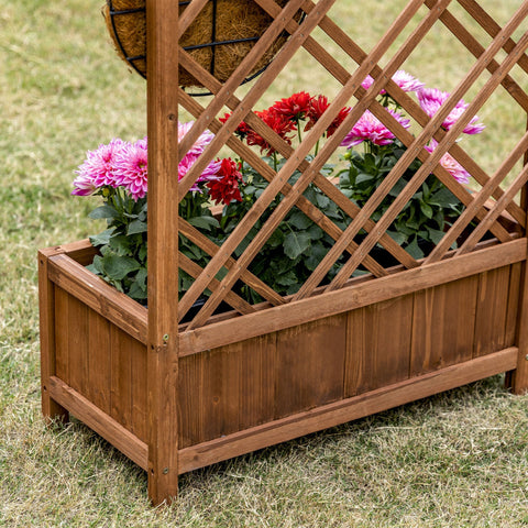 Brown wooden garden bed with lattice trellis made of fir wood holding vibrant red and pink flowers