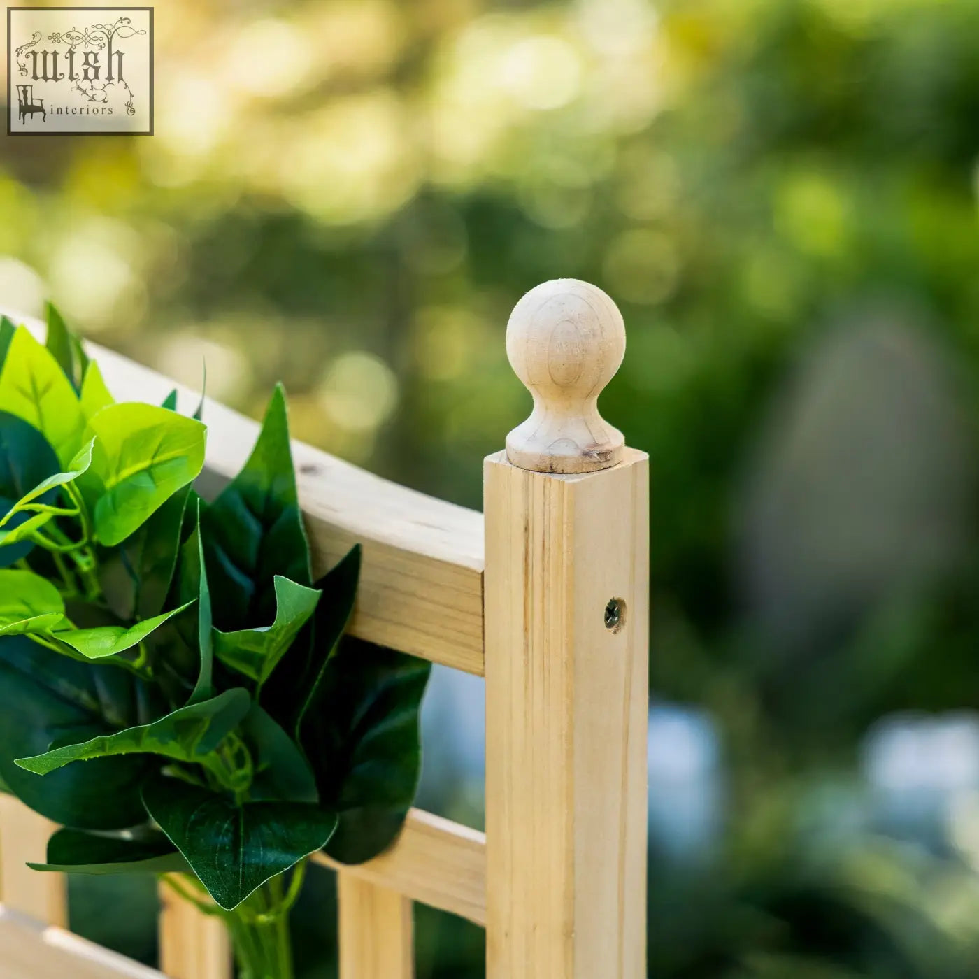Light-colored wooden fence post with rounded finial on outsunny garden planter with trellis for climbing plants and two leakage holes