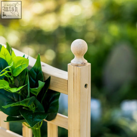 Light-colored wooden fence post with rounded finial on outsunny garden planter with trellis for climbing plants and two leakage holes