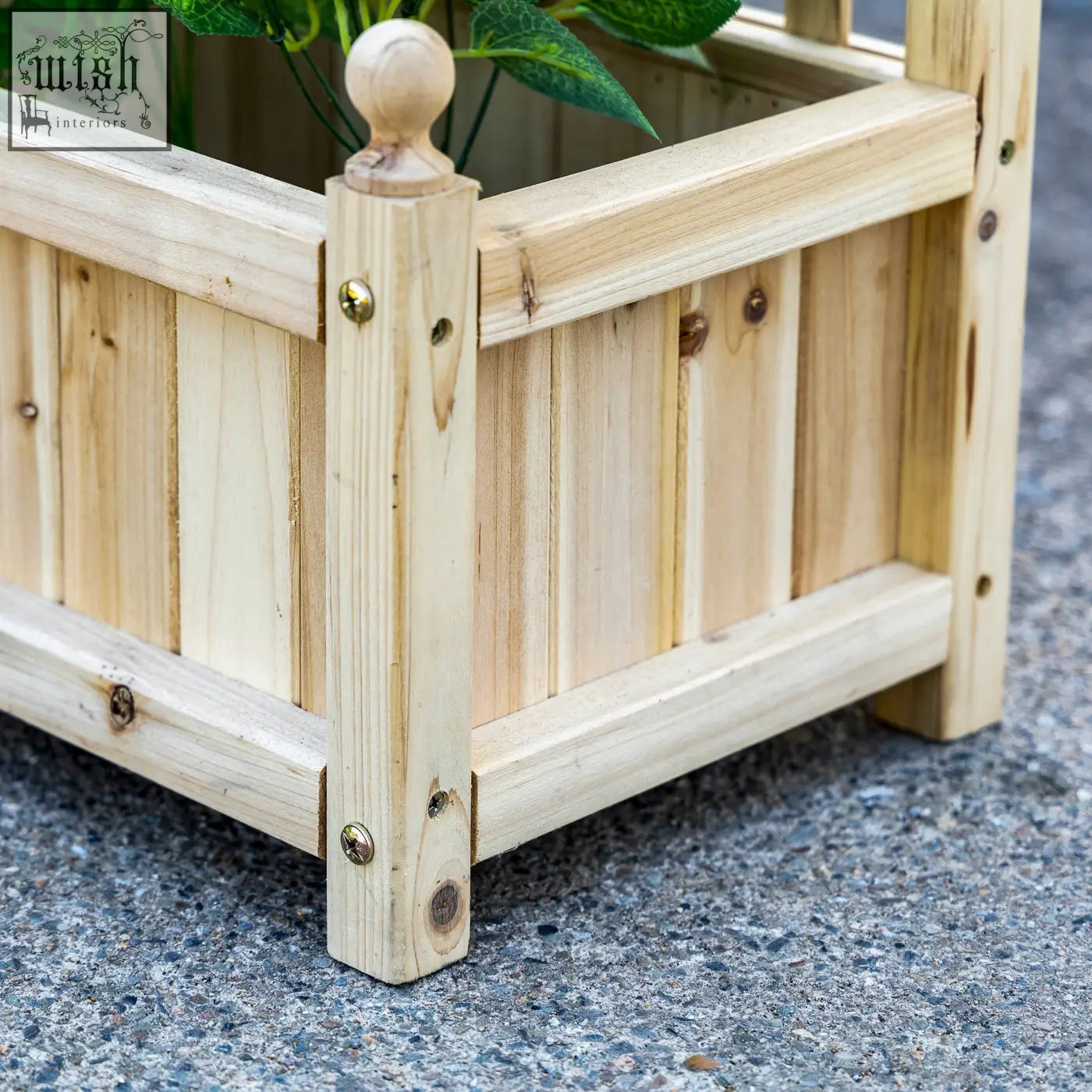 Light-colored wooden outsunny garden planter with vertical slats and two leakage holes for climbing plants