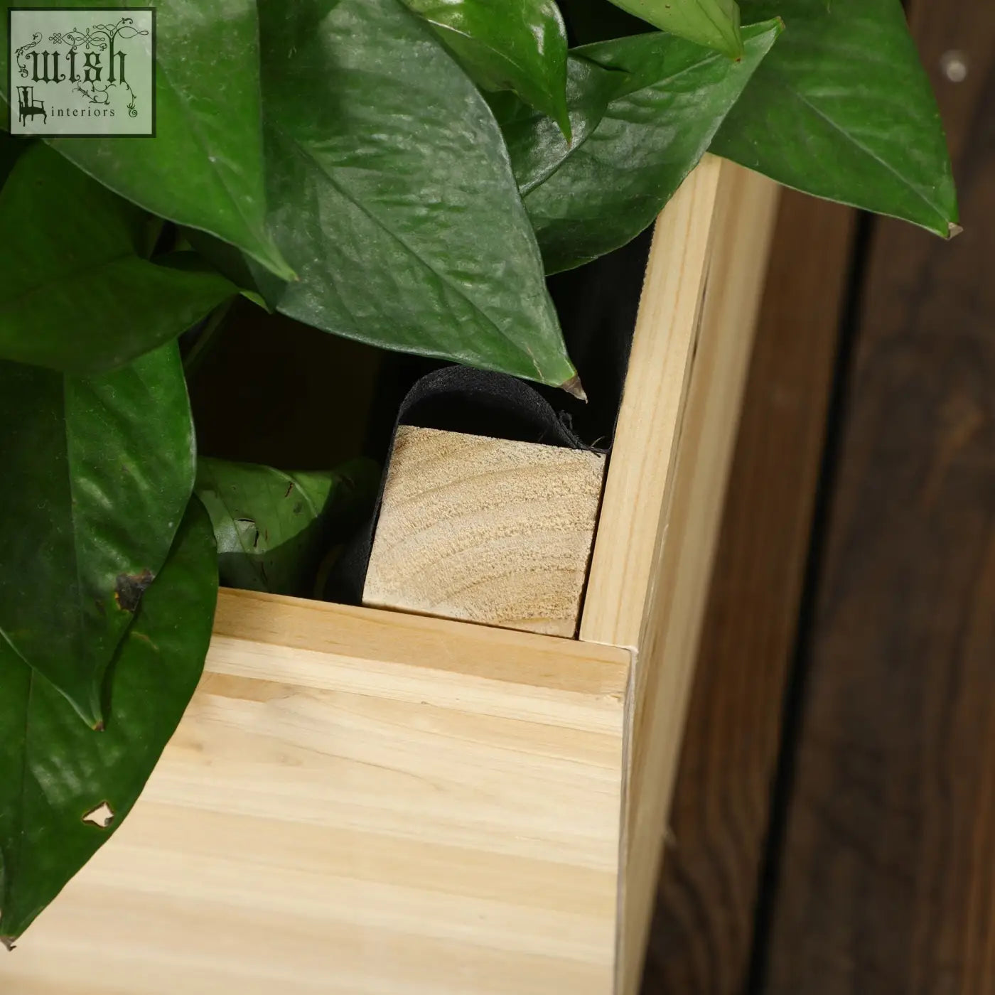 Light-colored outsunny garden bed with natural wood planter and trellis showing water drainage and fabric bag features