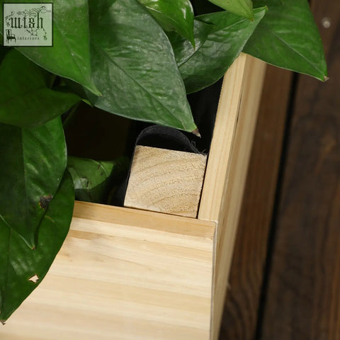 Light-colored outsunny garden bed with natural wood planter and trellis showing water drainage and fabric bag features