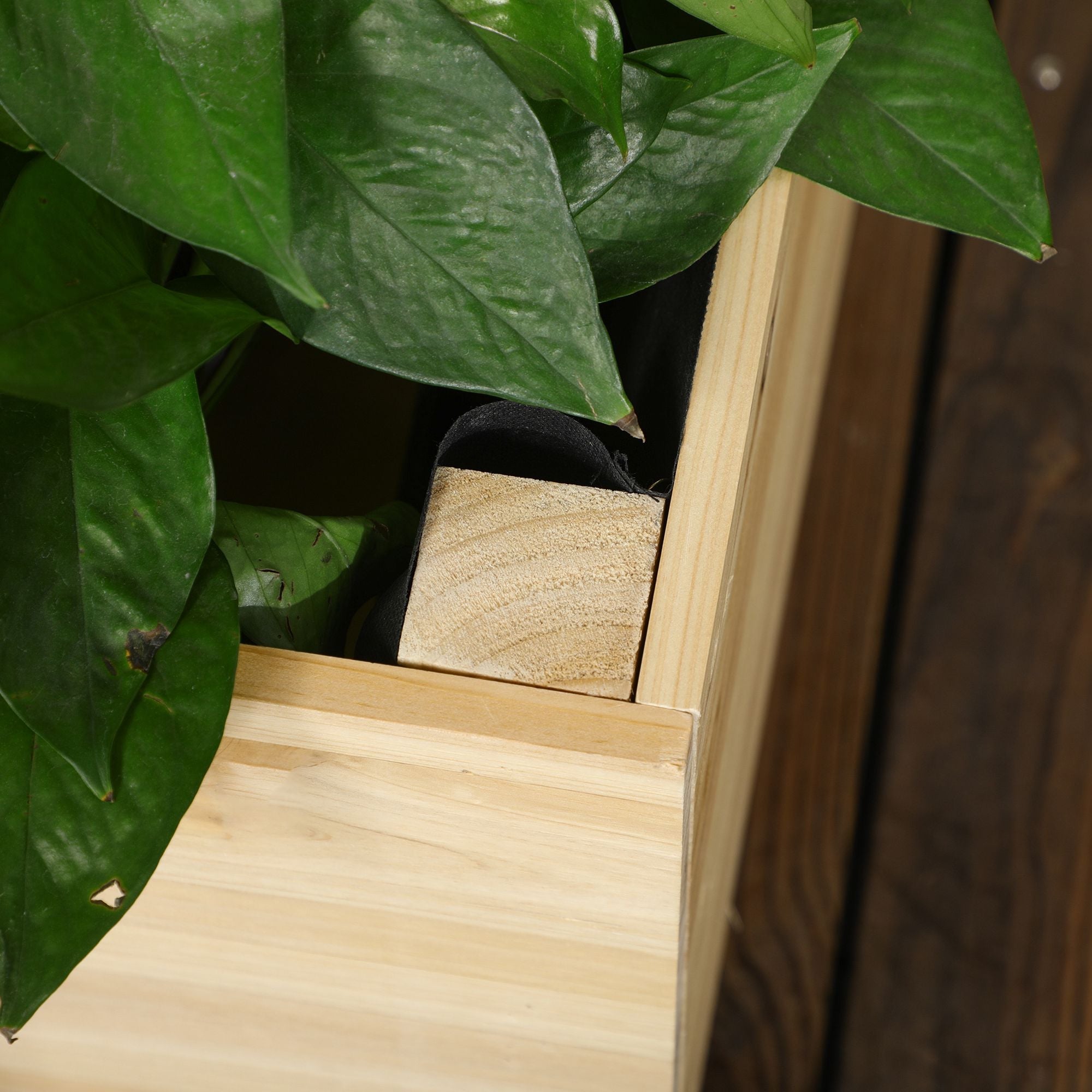 Light-colored wooden garden bed planter box with visible grain and square cutout for fabric bag or paint coating use