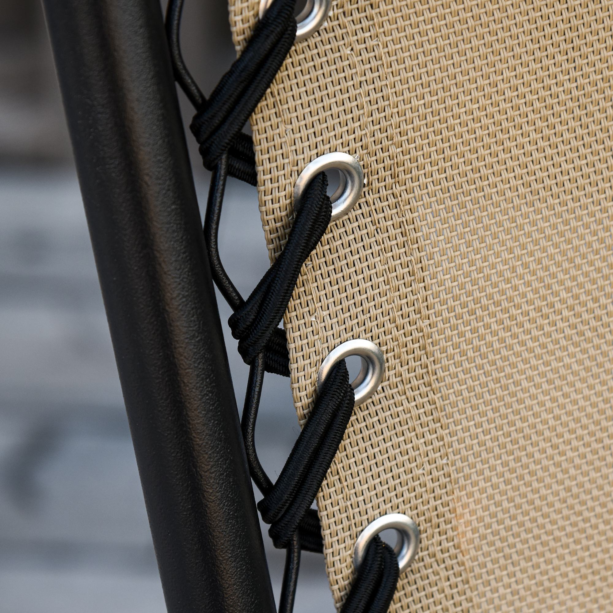 Beige woven mesh fabric with black elastic cords and silver grommets on a powder-coated steel frame garden rocking chair