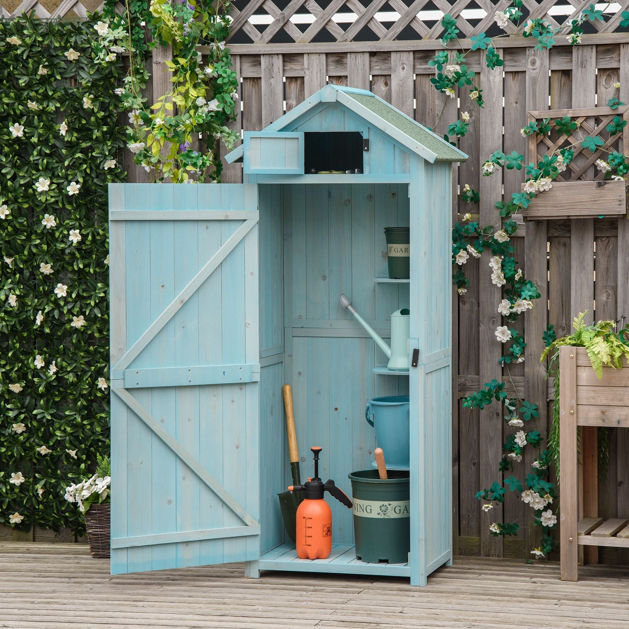 Light blue painted wooden outsunny storage shed with gabled roof and open door showing garden tools and small items inside