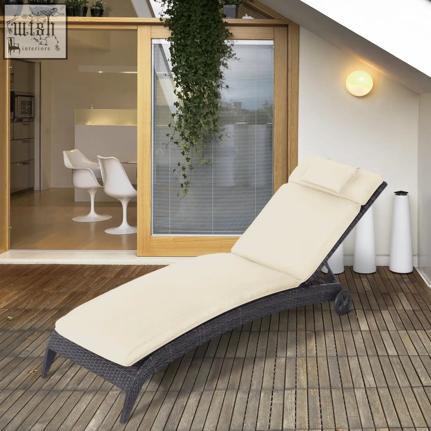 Dark gray wicker lounge chair with cream white thick lounger cushion and pillow for outdoor garden relaxation
