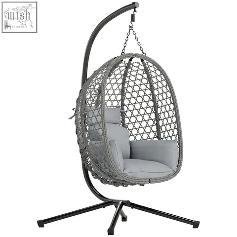 Gray woven wicker hanging egg chair with cushions and black metal stand featuring safety strap by outsunny
