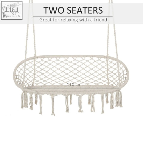 Cream-colored macrame hammock chair with woven mesh and fringe on metal frame hanging hammock chair for patio and porch
