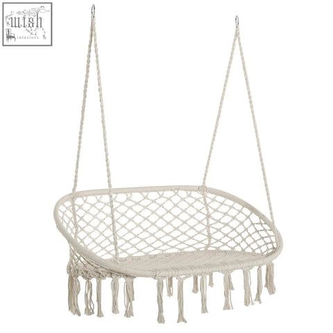 Cream-colored macrame hammock chair with fringe tassels and metal frame perfect hanging hammock chair for patio or garden