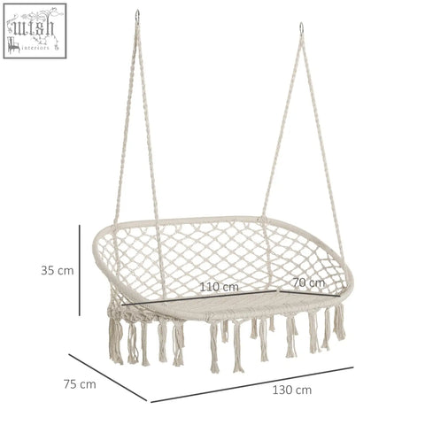 Cream-colored macrame hammock chair with fringe detailing and metal frame hanging hammock chair for patio and garden