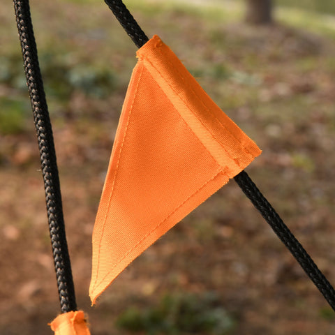 Bright orange triangular oxford fabric flag attached to black braided rope on outsunny kid nest swing seat
