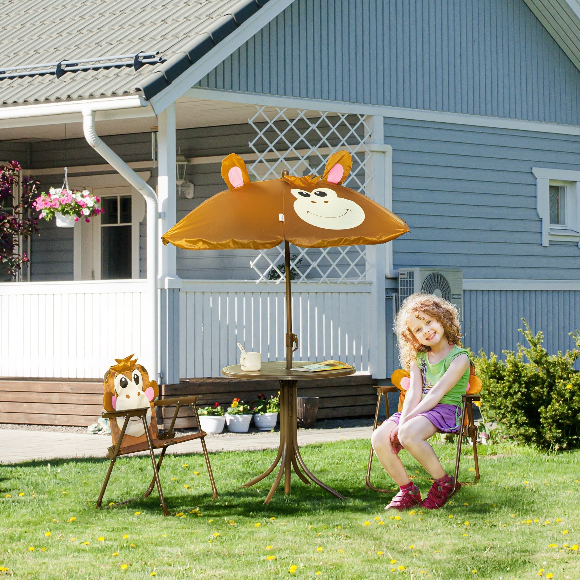 Orange monkey design sun umbrella with smiling face and pink ears on outsunny kids bistro table and chair set