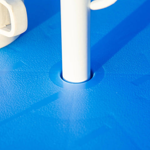 White plastic pole inserted into blue textured base of Outsunny kids outdoor bistro table with shark design sun umbrella