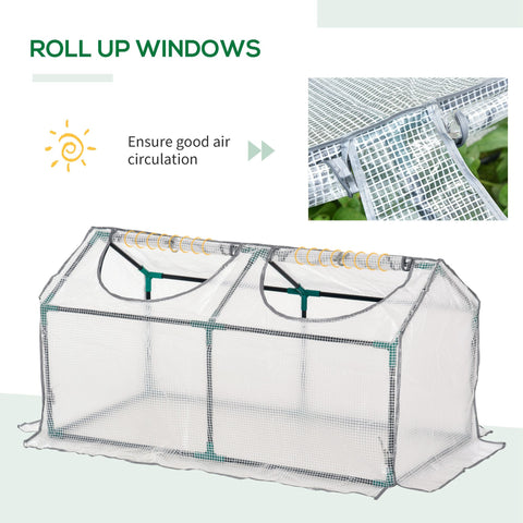 Outsunny mini greenhouse with clear plastic cover, green metal frame, roll-up windows, and 10cm extended size