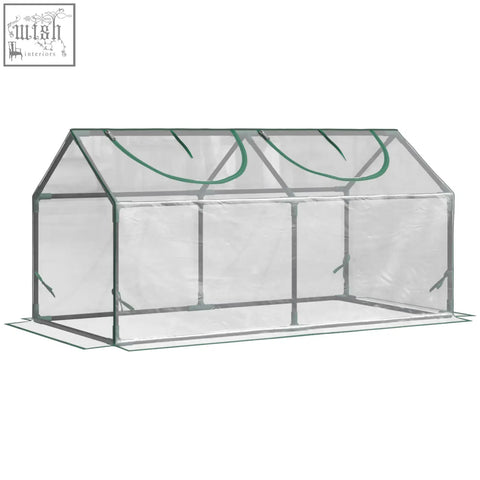 Clear plastic mini greenhouse with green trim metal frame and plastic cover for garden plants and vegetables