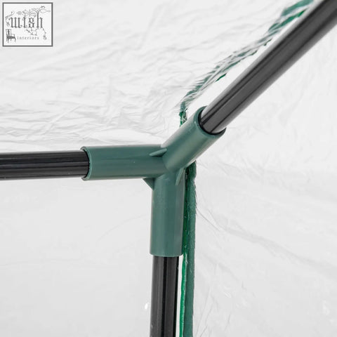 Green plastic corner joint connecting three black poles in outsunny mini greenhouse with plastic cover and zipped windows