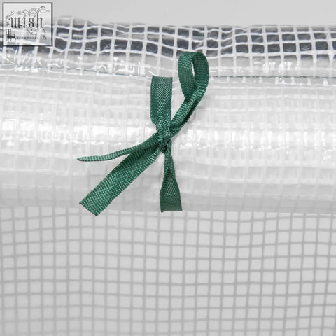 Outsunny mini greenhouse with white plastic mesh cover tied with green ribbon for plants and vegetables