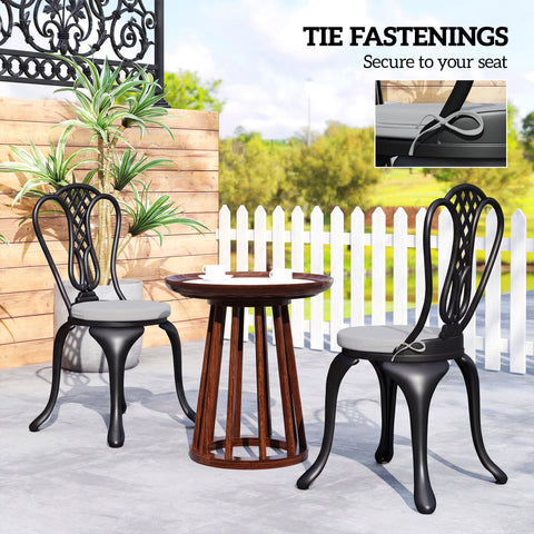 Black wrought iron patio chairs with light grey outsunny outdoor seat cushions and removable covers for comfort