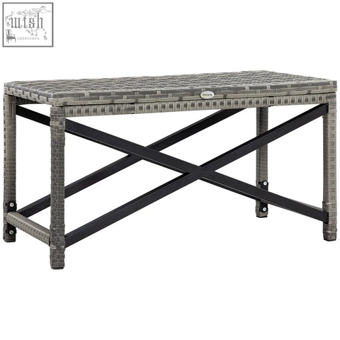 Gray woven resin outdoor coffee table with mixed grey plastic top and black metal x-shaped frame for patio use