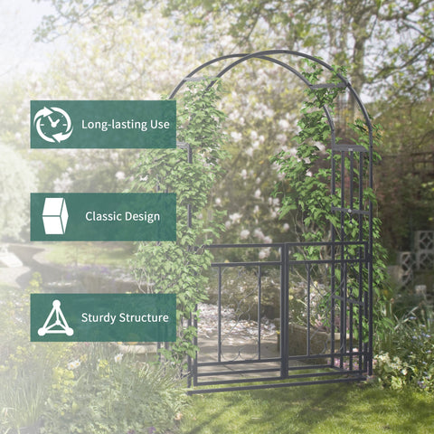 Dark grey wrought iron garden arbor with double gates and curved arch partially covered in green ivy for climbing plants