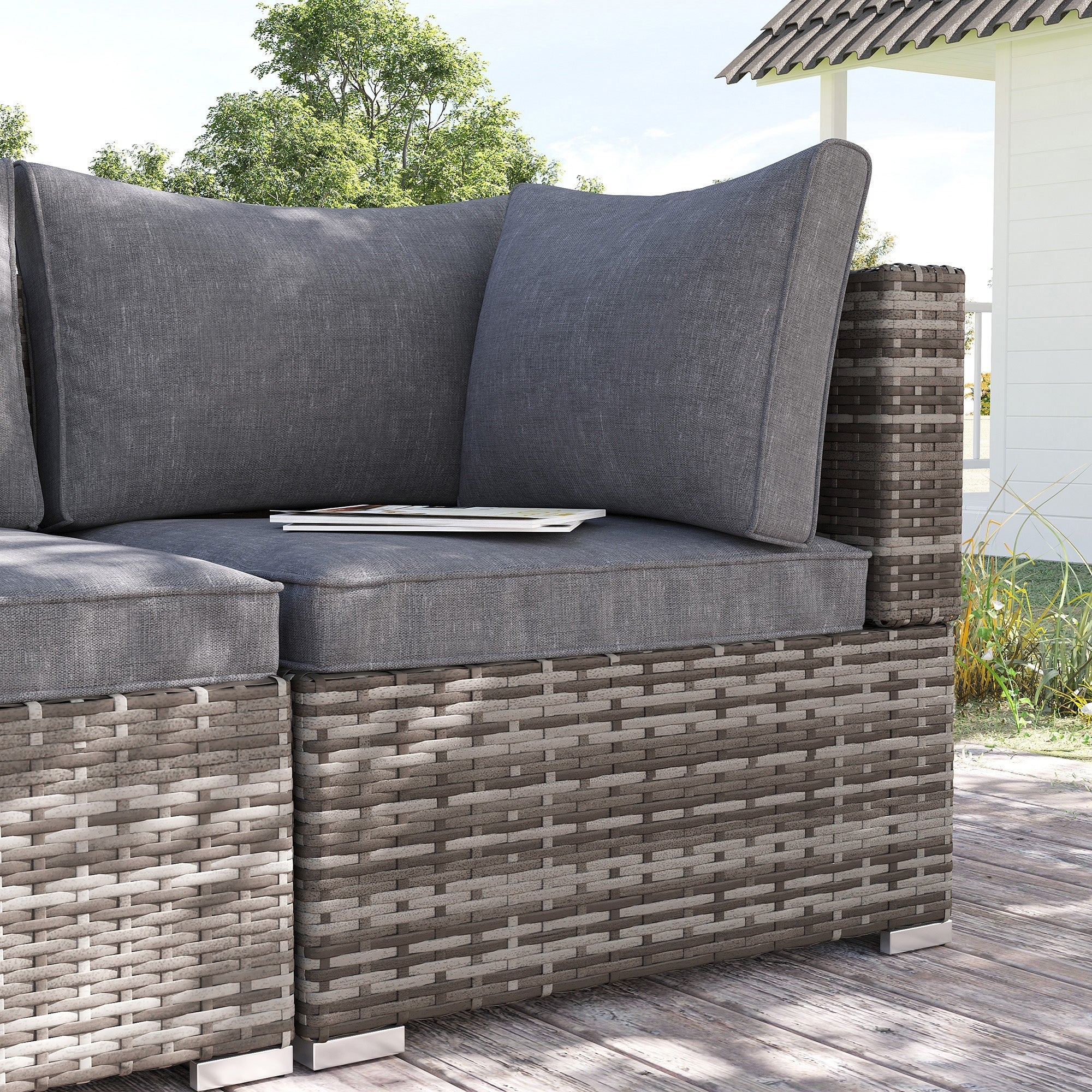 Gray woven rattan corner sofa with deep grey seat cushions perfect for outdoor garden seating