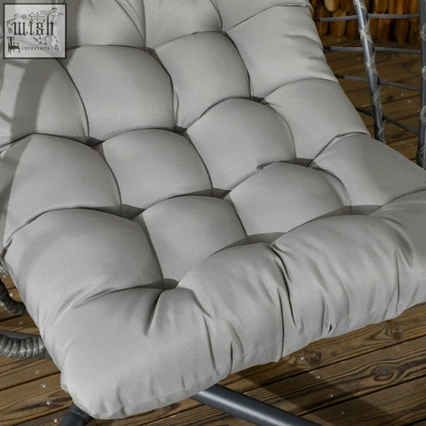Gray tufted cushion with a soft, plush texture and subtle stitching details.