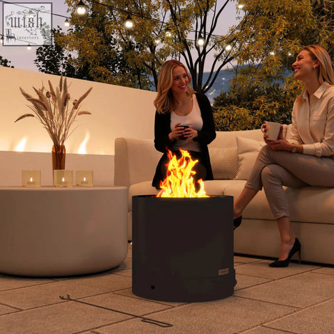 Dark gray outsunny outdoor round fire pit with active flames and pull-out ash tray in black steel design