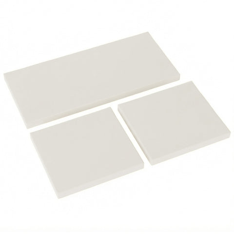 Three off-white ceramic tiles arranged diagonally next to cream white outsunny seat cushion pads for rattan furniture