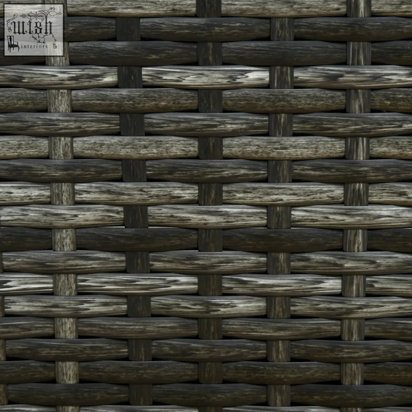 Dark gray woven rattan sun lounger with rustic weathered finish and soft padded cushion for patio or garden use