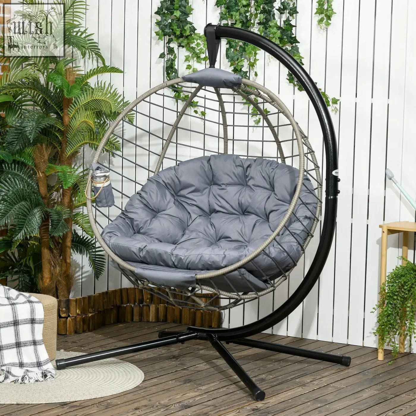 Gray cushioned outsunny swing chair with woven PE rattan foldable basket and black metal support for indoor outdoor use