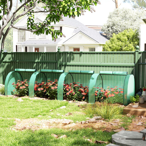 Green outsunny tunnel greenhouse with steel frame and zipped doors protecting backyard flowering plants