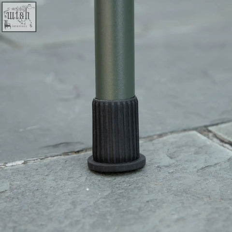 Black rubber foot with ribbed texture and flat base supports outsunny portable charcoal grate for airflow and stability